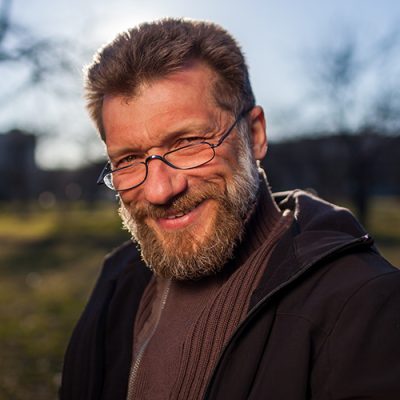 Portrait of a mature man in glasses on a background of nature.