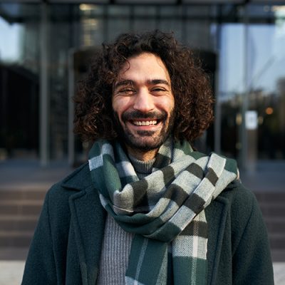 Young Caucasian businessman looking camera smiling. Cheerful male smiling for the successes of work. High quality photo